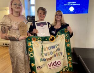 Image of Becks, Marilyn and Karen accepting the Charity Hero Award from the Benefact Group for Vida Sheffield